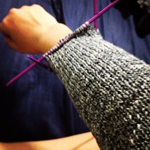 sweater sleeve being test-fitted
